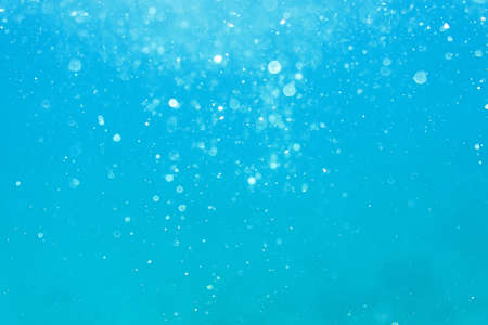 Underwater turquoise texture in ocean. Bubbles in tropical sea. abstract underwater bokeh and bubbles backgroundの写真素材