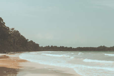 Vintage photo of beautiful beach landscape with cloudy sky and sea with waves. Andaman and Nicobar Islands. India. Indian ocean. retro toningの写真素材