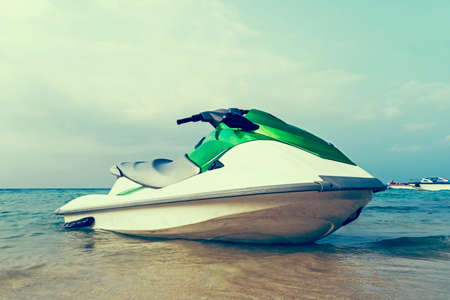 Jet ski moored in shallow water off a beach ready to be taken out to sea by holidaymakers and...