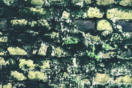 abandoned grunge cracked brick stucco wall background. Old, decayed wall with peeling plaster.