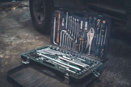 tool cabinet with open case at service station, shallow dof. Tool box. Toolset with interior compartments to keep wrenches, ring spanners, hammer, pliers, screwdrivers, monkey wrenches, screws boltsの写真素材