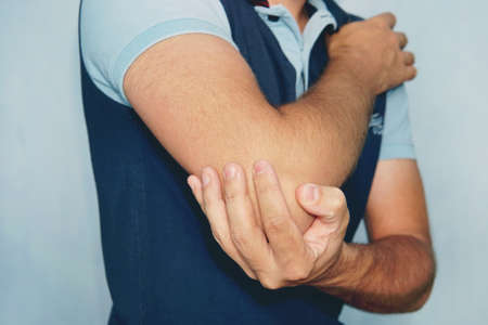 Man With Pain In Elbow. Pain relief concept.の写真素材