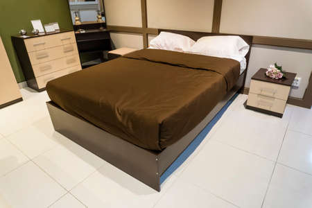 Bedroom interior design. Large bed blanket Brown Color and white pillows, Nightstand, dresser, mirrorの写真素材