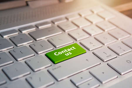 A 'contact us' message on enter key of keyboard, for online communications.の写真素材