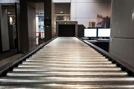 X-ray machine at the airport check-in counter. Baggage check. The scanning of hand Luggage. Airport security system.の写真素材