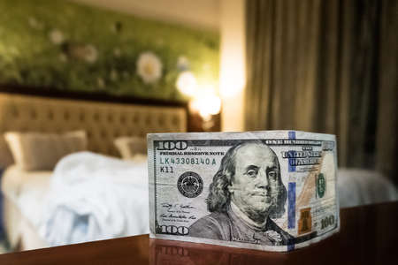 bed and money to symbolize the cost of sex. Paid love the prostitute. Payment for the services of...