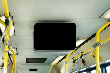 black TV without information inside the bus. Video advertising in public transport. train station, bus terminal. Billboard in a public place. Mock up electronic media board with copy spaceの写真素材