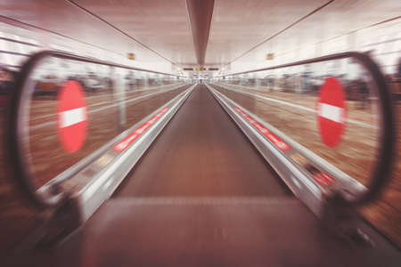 Moving waklway in the airport terminal, travel concept. straight flat escalator. motion effect. entry banned a badge of. there is no way.の写真素材