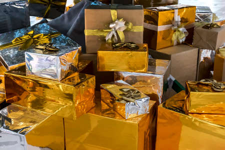 Lots of Gift boxes on white background. Presents in craft and colored paper decorated with red satin ribbon bows. Christmas and other holidays concept.の写真素材
