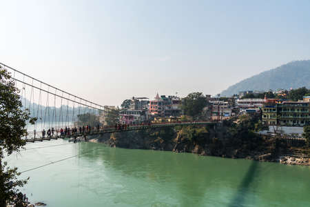 A photo of the Rishikesh Valley from the Lakshman Jhula iron suspension bridge across the River Ganges in the holy city of Rishikesh, North India.の素材 [FY310109286624]