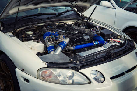 Open hood car with the view of an engine. Engine failure. motor runs rough. car want a repair....