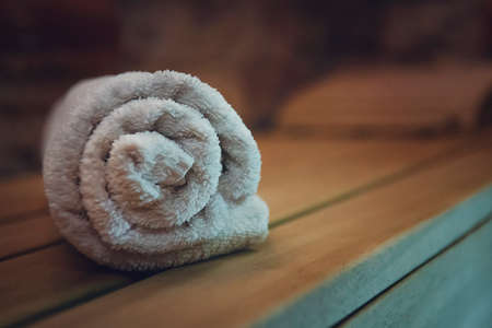 Traditional wooden sauna for relaxation with a set of clean towels. Good quality service in a classical steam sauna. First-class amenities of an eco-designed sauna. A towel put for using in sauna.の写真素材