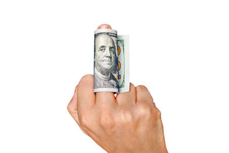 Man shows middle finger with dollar bill on it. Concept of bribe, dishonesty, hypocrisy. isolated on white background. show the middle finger. To give or take bribe, bribe taker, official, dishonestの写真素材