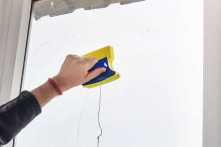 washing and cleaning the window with a squeegee. Washing the window with a magnetic brush....