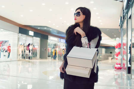 Female hands holding a shopping bags