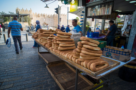 Sellers on the market sell bagele - traditional arab bread. Old city, Jerusalem. ISRAEL. 24 October 2018のeditorial素材