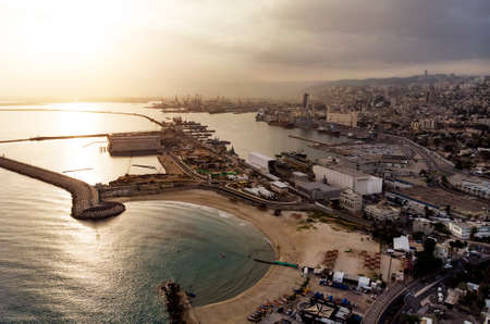 Haifa Beach, Israel, aerial view. Sunrise over the sea. The sun rises from the horizon. Top view of the seaside town of Haifa. The sea Port in Haifa.の写真素材