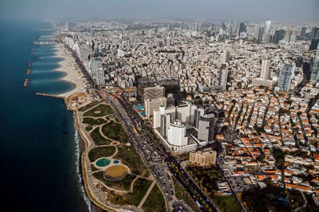 view from the shore to the modern district of Tel Aviv. Top view of the capital of Israel. Clean beautiful beach in the city center of the metropolis on the background of high skyscrapers.の写真素材