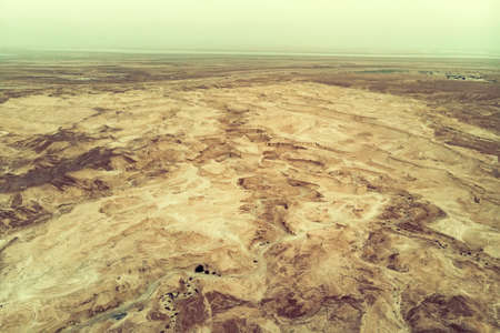 Top view from Masada fortress to the Judaean desert and the Dead Sea. The desert land of Israel. Background of canyon in the desert. Desert in which 40 years Moses was looking for the promised landの写真素材