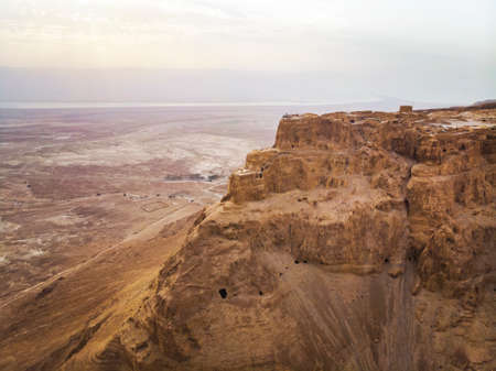 Masada fortress area Southern District of Israel Dead Sea area Southern District of Israel. Ancient Jewish fortress of the Roman Empire on top of a rock in the Judean desert. front view from the airの写真素材