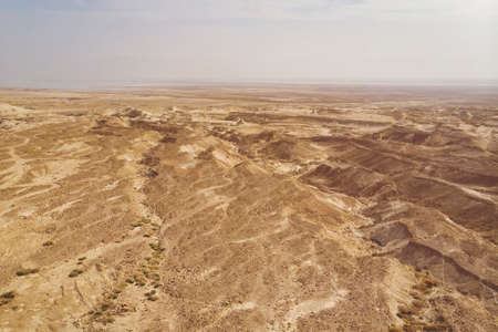 Sand dunes against the sky. Beautiful desert landscape. Desert close-up. udean desert located on the West Bank of the Jordan river. Deserted shore of dead sea. The background of desert. barren landの写真素材
