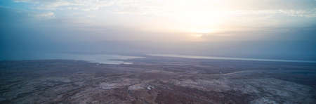 dawn of the dead sea panorama. Beautiful sunset on the dead sea in front of the Judean desert. The sun Peeps out from behind the clouds. Beautiful Landscape of Israel or Jordanの写真素材