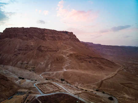 Snake trail to climb the ancient fortress of Masada. The beginning of the pedestrian road. Modern building in the desert. Judean Desert, Israel.の写真素材