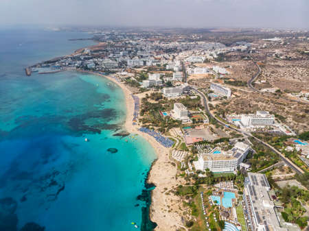 Cyprus beautiful coastline, Mediterranean sea of turquoise color. Houses on the Mediterranean coast. Tourist town with a Long beach. Summer vacation at sea. top view, aerial view. Cyprus, Ayia NAPA.の写真素材