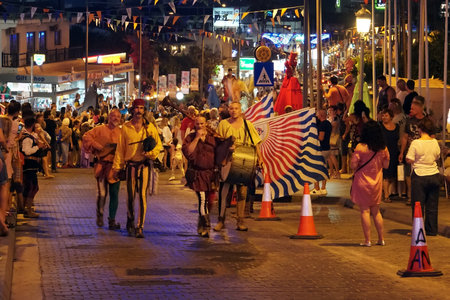Annual festival of Medieval cultures of Europe. The procession of the column in the carnival historical costumes of the city at night. Cyprus, Ayia NAPA. 19 October 2018のeditorial素材