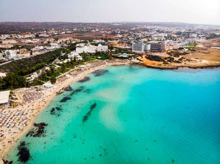 Cyprus beautiful coastline, Mediterranean sea of turquoise color. Houses on the Mediterranean coast. Tourist town with a Long beach. Summer vacation at sea. top view, aerial view. Cyprus, Ayia NAPA.の写真素材