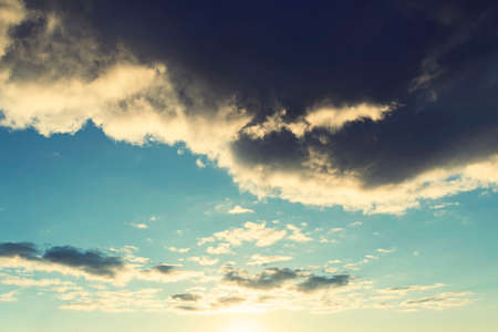 black cloud like storm, dramatic sky. Big black gloomy rain cloud in the sky over the cloudless blue sky. bad weatherの写真素材