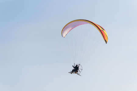 Adventure man active extreme sports pilot flying in the sky with paramotor paraglider paraglider motorの写真素材