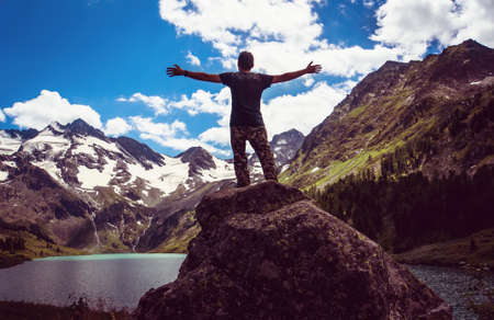 Happy man Traveler raised hands mountains and lake landscape on background Travel Lifestyle concept adventure summer vacationsの写真素材