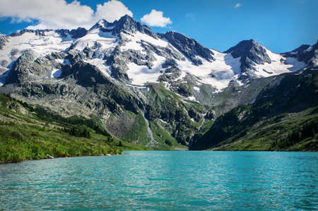hill and water lake with clear summer sky. Beautiful summer landscape in the mountains of Siberia.の写真素材
