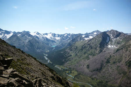 scenic mountain landscape. Mountain snow-capped peaks. River flowing through a canyon between two mountainsの写真素材