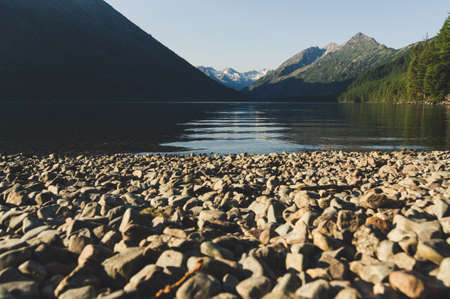 Landscape with the image lake and the mountains in Altai. Warm sunny day in Siberia. Crystal clear water of lake. Summer relax on the widelyの写真素材