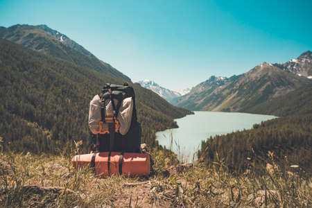 touristic backpack on the riverbank. Hike conceptの写真素材