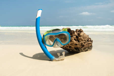 Mask and snorkel in the surf on the sandy beach selective focus.の写真素材
