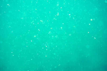 Underwater turquoise texture in ocean. Bubbles in tropical sea. abstract underwater bokeh and bubbles backgroundの写真素材