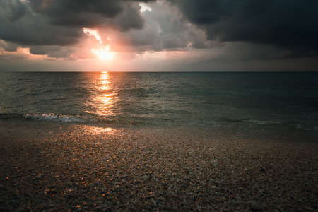 cloudy sunset over the sea in a rocky beach with stones and red dusk. epic sky. Andaman and Nicobar Islands. Neil to Havelock Goa Kerala Indiaの写真素材
