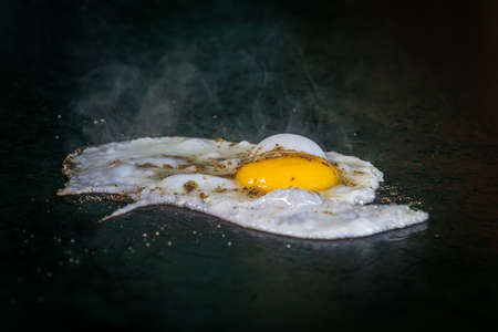 Fried eggs fried eggs in a pan. Hot appetizing dish that is eaten unmarried men and poor students. one fried eggの写真素材