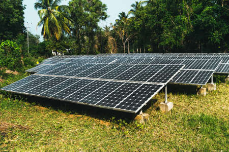 Large solar panels in the rainforest. Alternative solar energy. Electrification of the Andaman Islands. photovoltaic battery in the forest among the palm treesの写真素材