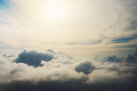 Under the clouds shot from a bird's flight, the sun shines on the clouds. dark clouds. Views of clouds from above. Storm. cumulonimbus. Storm. hurricaneの写真素材