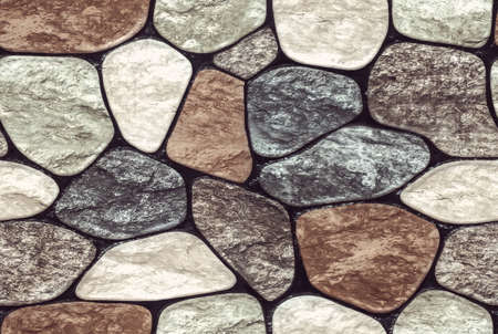Wall round stone rock texture and seamless background. pale color of the stones. Marble texture.の写真素材