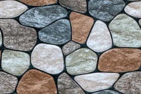 multicolored stone with rounded faces wall background. Seamless backgroundの写真素材