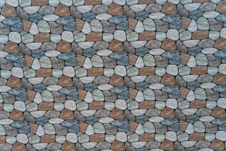 multicolored stone with rounded faces wall background. Seamless backgroundの写真素材