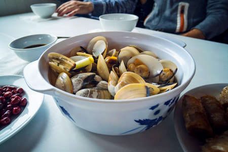 cooked open blue mussels on the table in the potの写真素材