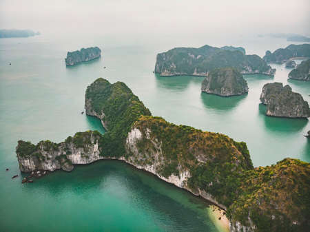 Beautiful view of Halong Bay from the height. Top view of the rocks sticking out of their water. northern vietnam. Seascape. Mountains in fog.の写真素材
