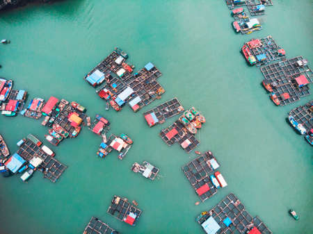 Aerial view of floating villages around Cat Ba islands. Cat Ba is the largest of the 366 islands, which make up the southeastern edge of Ha Long Bay in Vietnam.の写真素材
