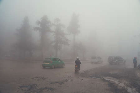 Transport on the road on heavy fog days Can't see the way forward, Heavy fog in the mountainous city of Sapa Vietnam.の写真素材
